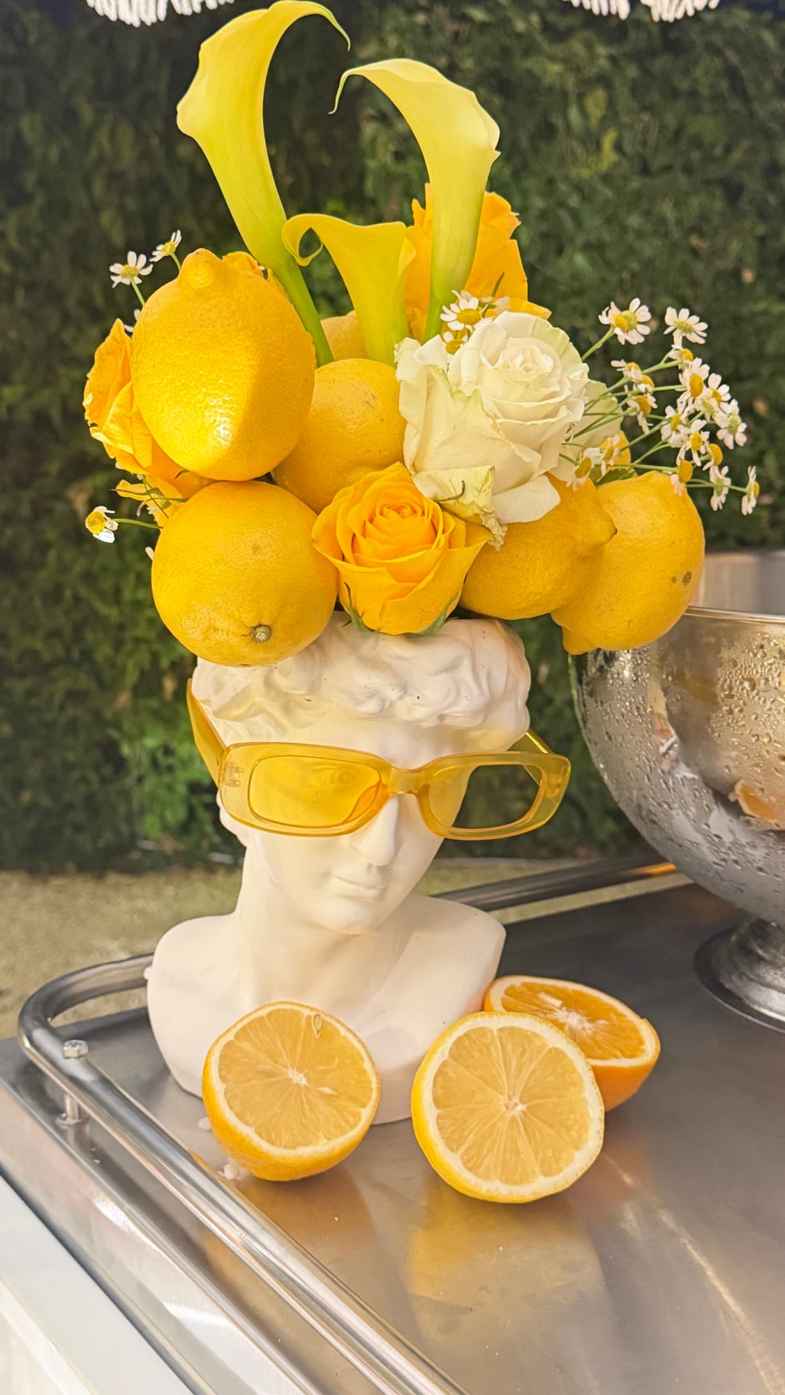 Busto decorativo con limoni, rose e occhiali gialli allo sweet corner