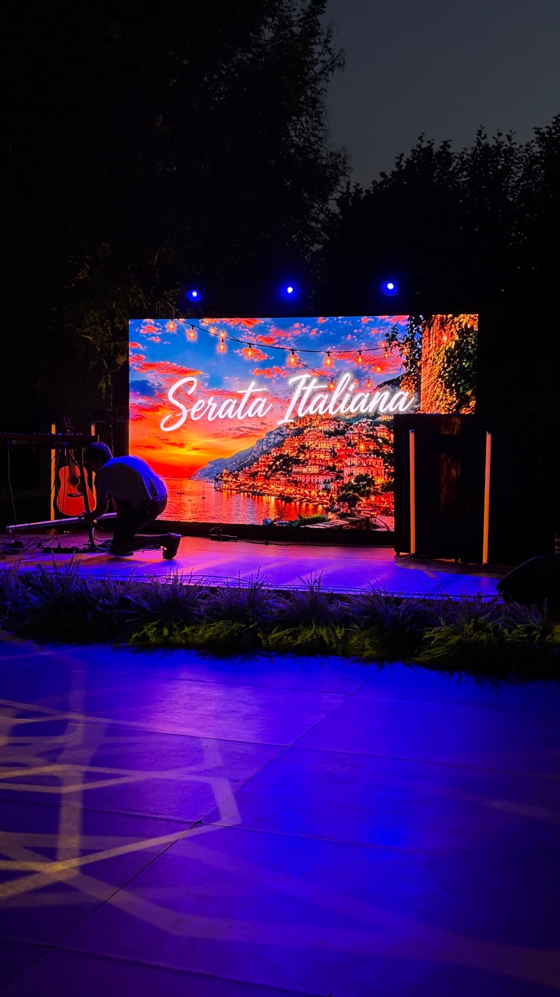 Palco con maxischermo Serata Italiana e luci blu in giardino